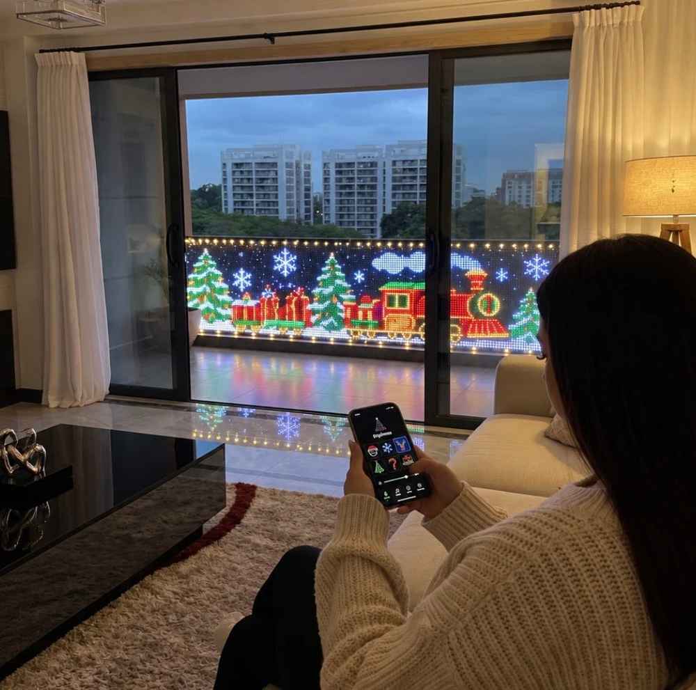 Christmas curtain lights viewed from inside a living room