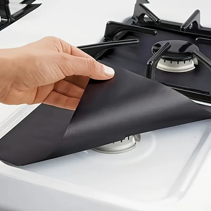 Installing black reusable gas stove burner protector liner