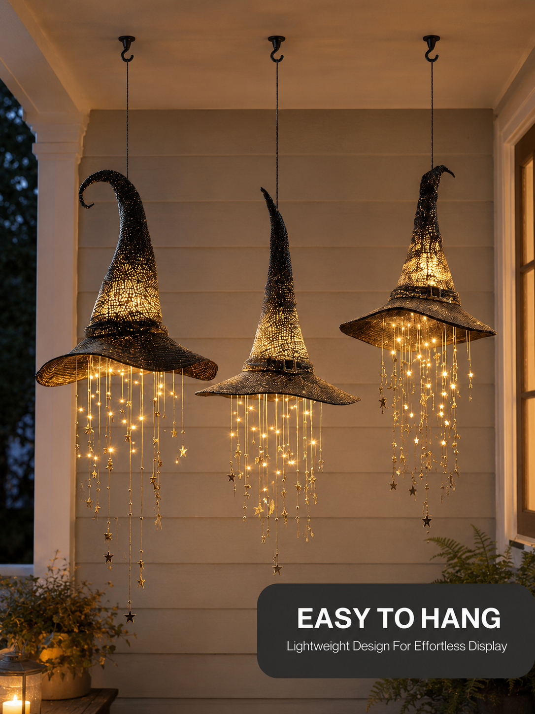Three hanging witch hats displayed from ceiling hooks