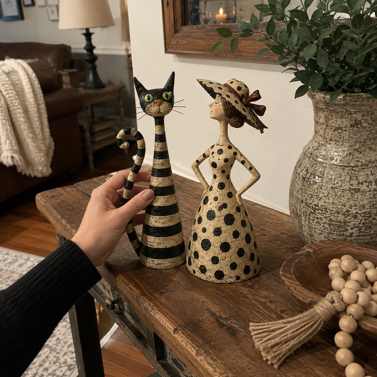 Vintage cat and lady sculpture styled on wood console table