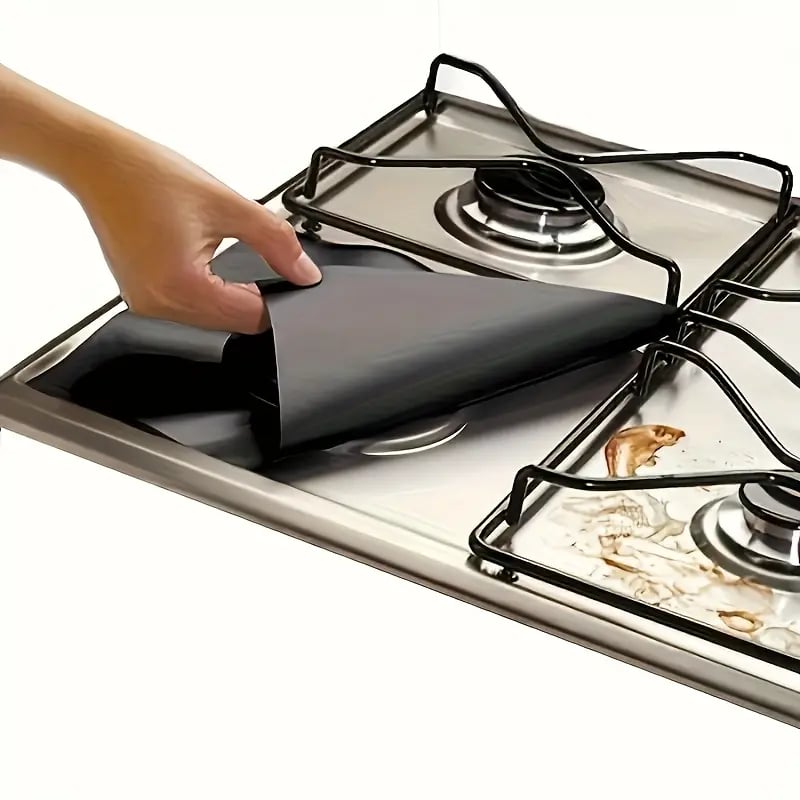 Gas stove protector liner lifting away from messy stovetop